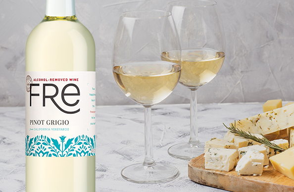 bottle and glasses of FRE alcohol-removed pinot grigio next to a plate of cheese