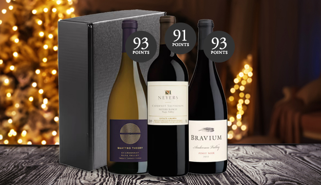 top rated holiday wine gift set on a table in front of a brightly light christmas tree